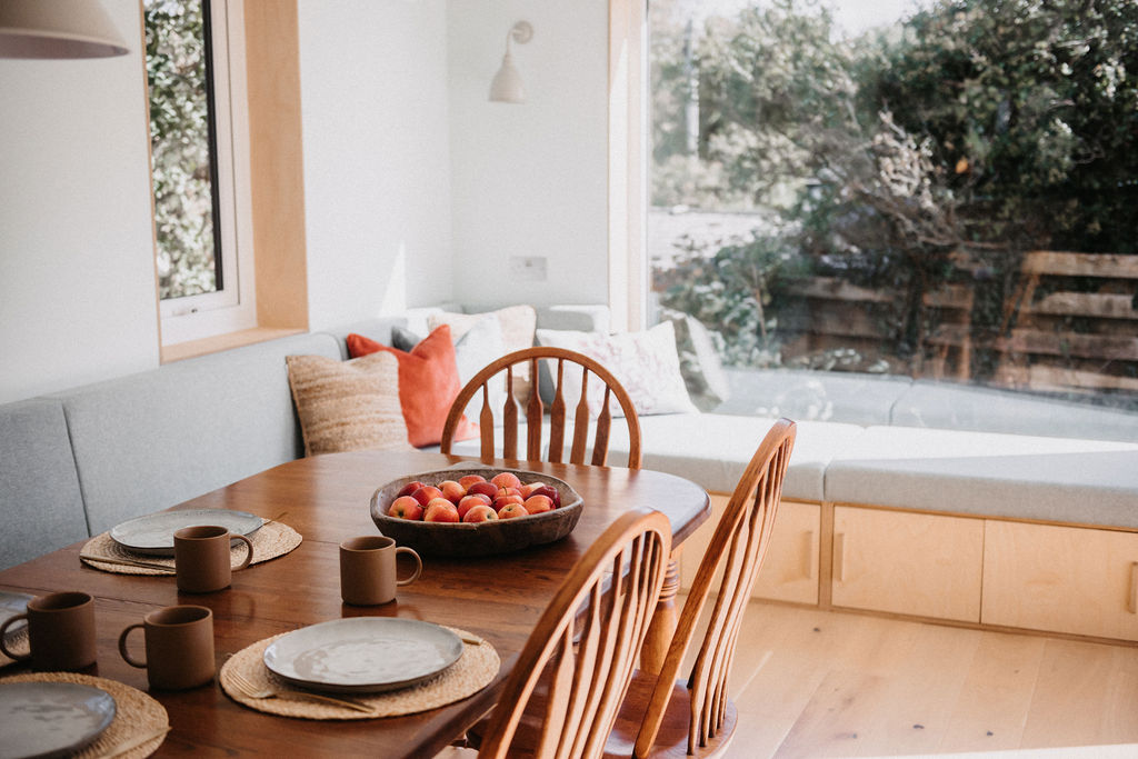 mugs on the table with a bowl of apples