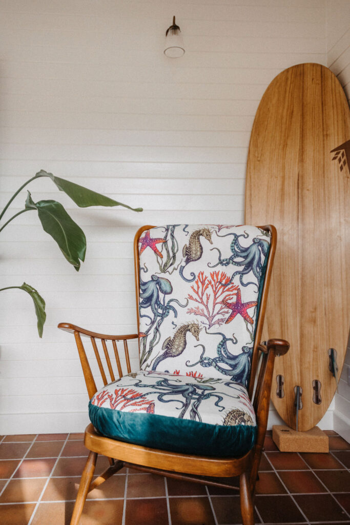 lamp in the shiplap wall with surfboard and chair