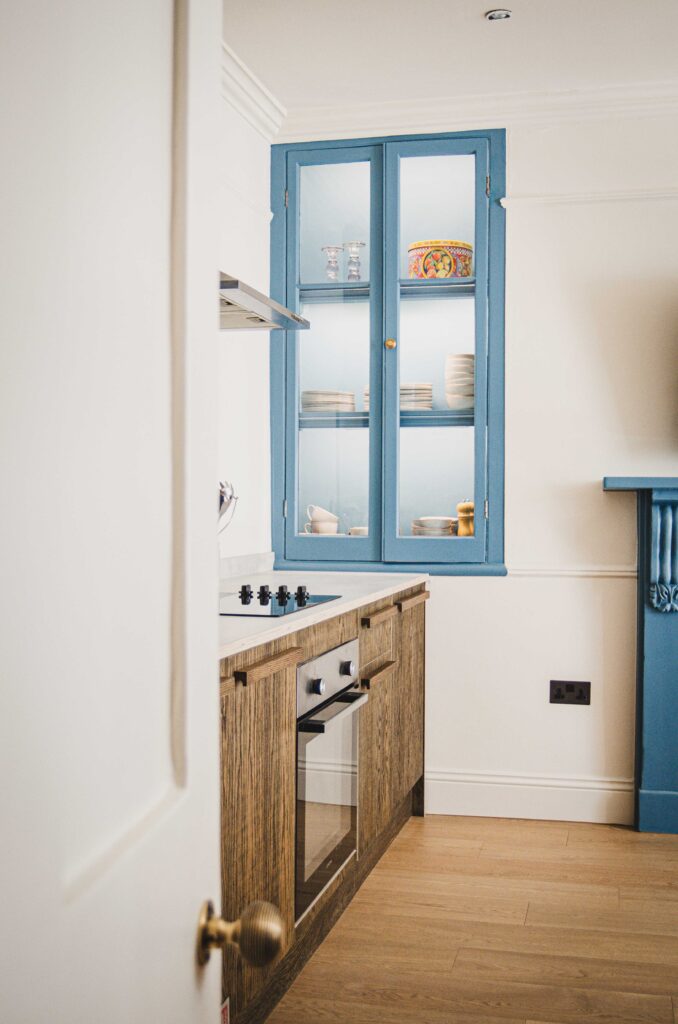 Looking through to the kitchen and blue display cabinet