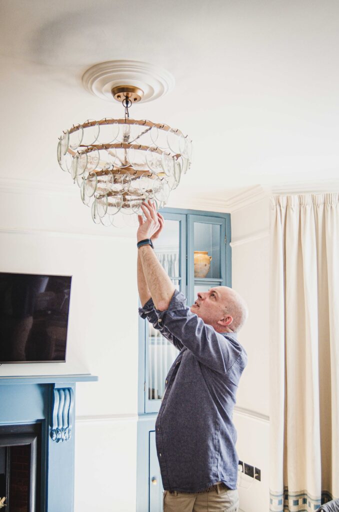 Local specifications - Stephen adjusting a pendant from Devon based B Corp Nkuku.